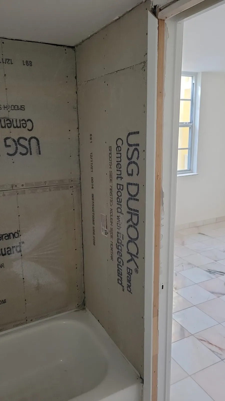 Shower or tub area under renovation with cement board and cavity.