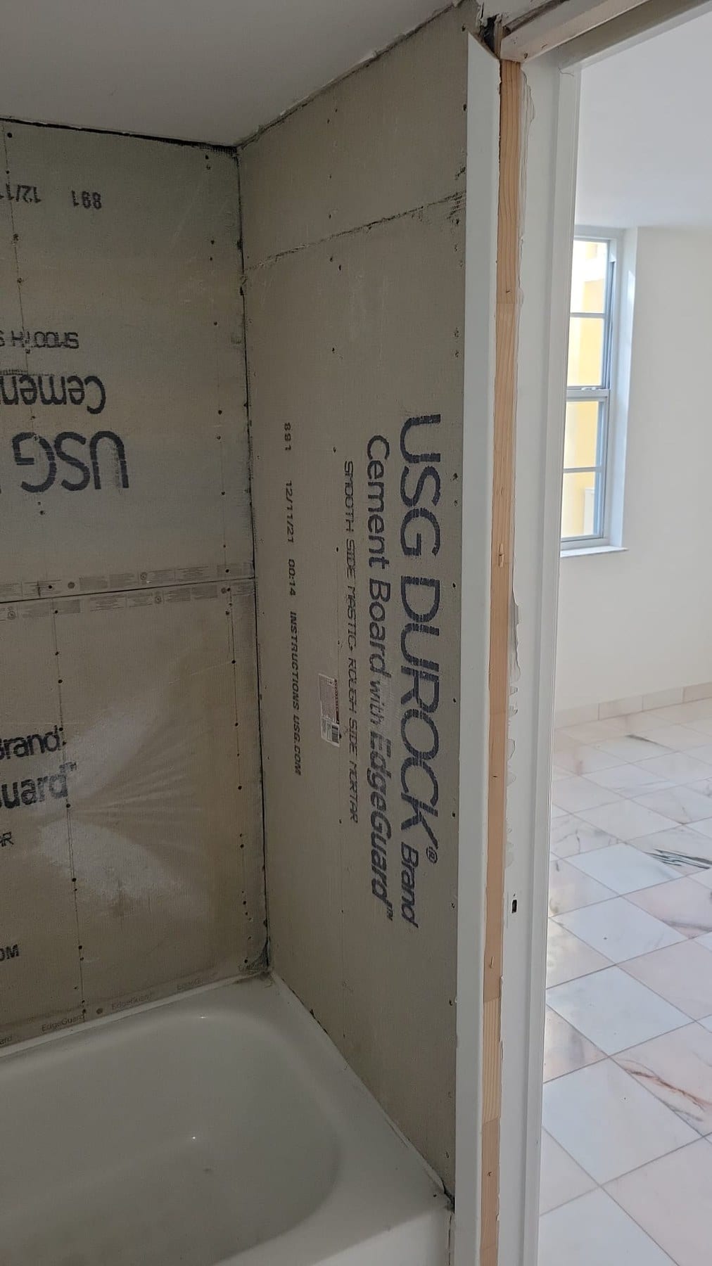 Shower or tub area under renovation with cement board and cavity.